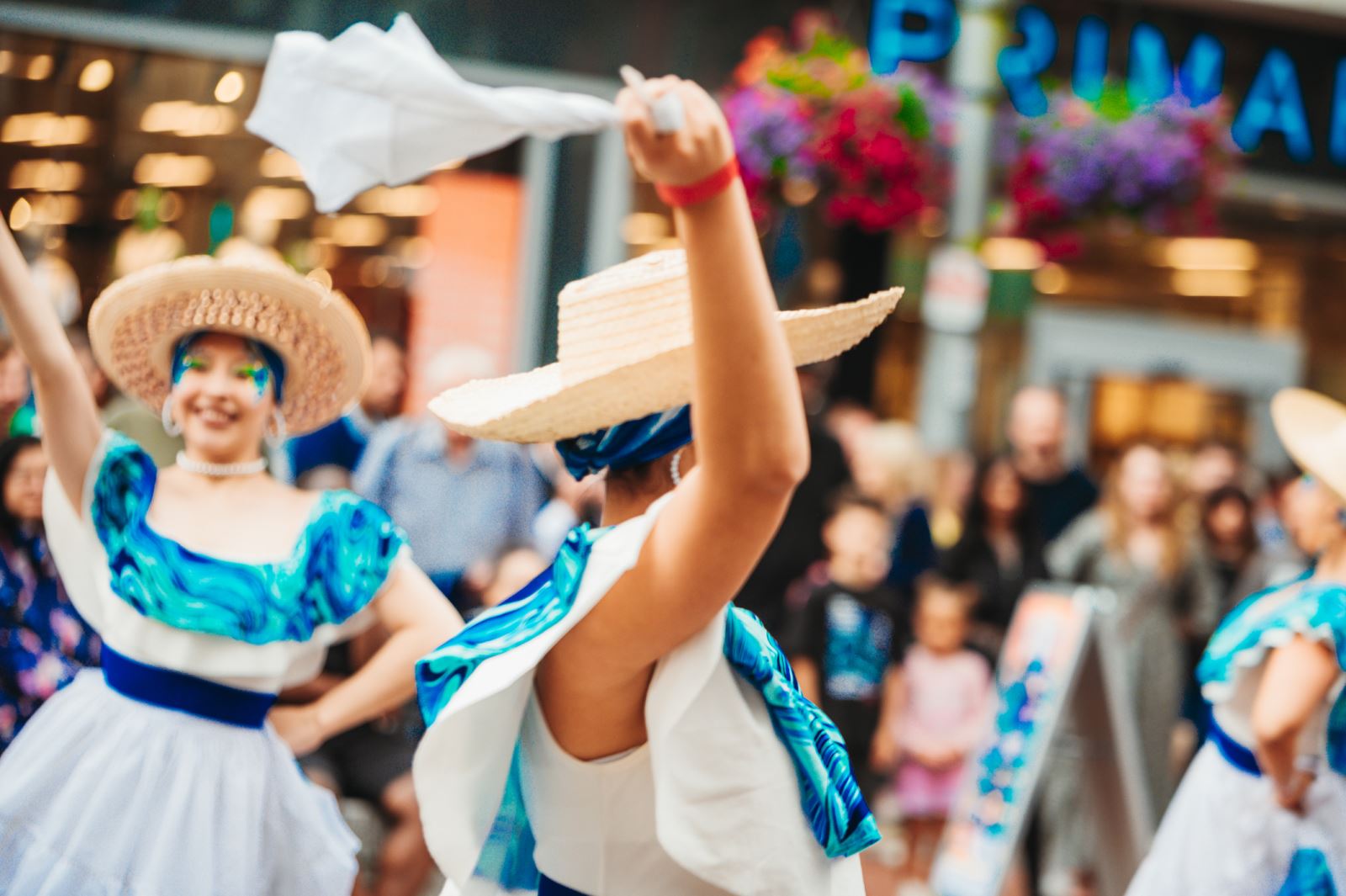 Ladies dancing in blue and white dresses on the highstreet